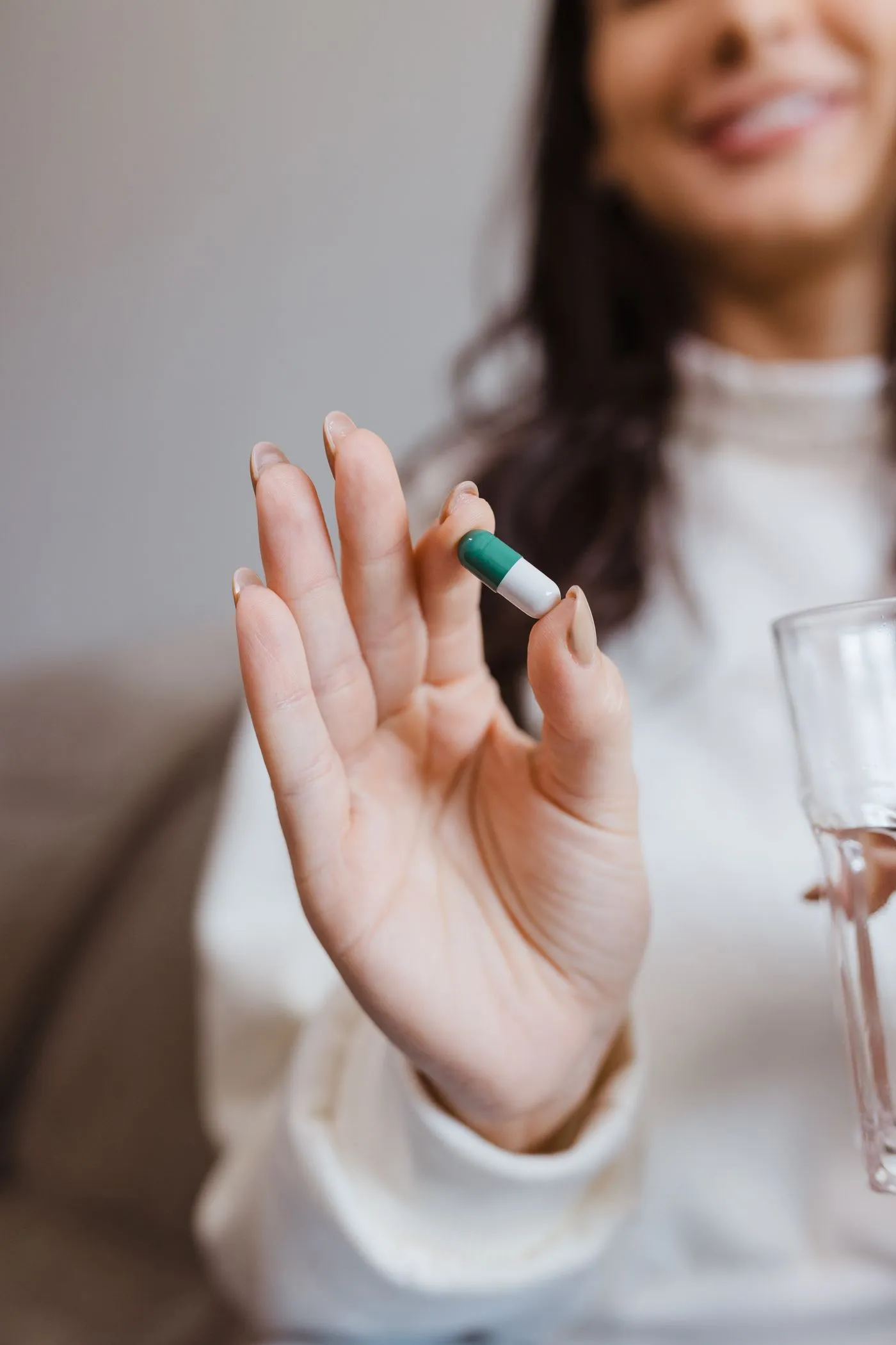 BerbaLean Reviews: Does This Berberine Weight-Loss Supplement Work? 5 A hand holding a daily BerbaLean capsule with a glass of water