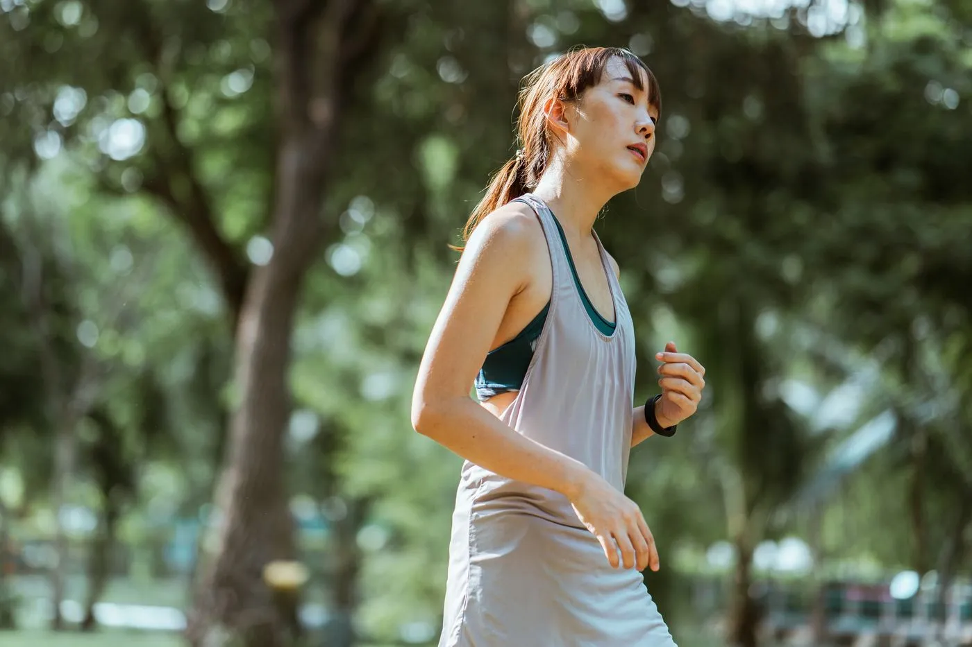 Best Weight Loss Supplements (2026): 2 Picks We Rate Honestly 4 Woman jogging outdoors in a park, representing the daily movement that drives weight loss