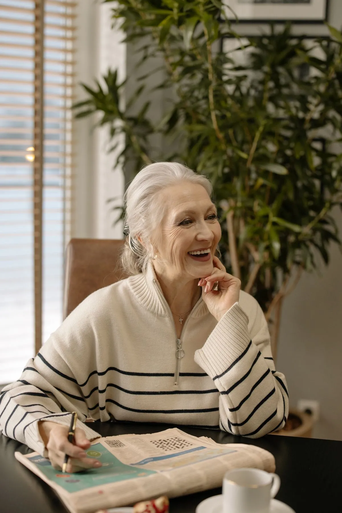 Prevagen vs Neuriva (2026): Which Memory Supplement Is Worth It? 1 Sharp, smiling older woman doing a crossword puzzle at home