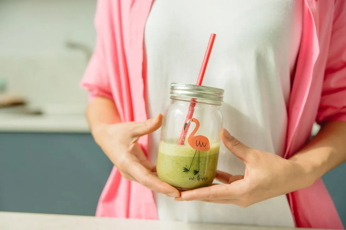 DigestSync Reviews 5 Person holding a green smoothie made with the daily powder