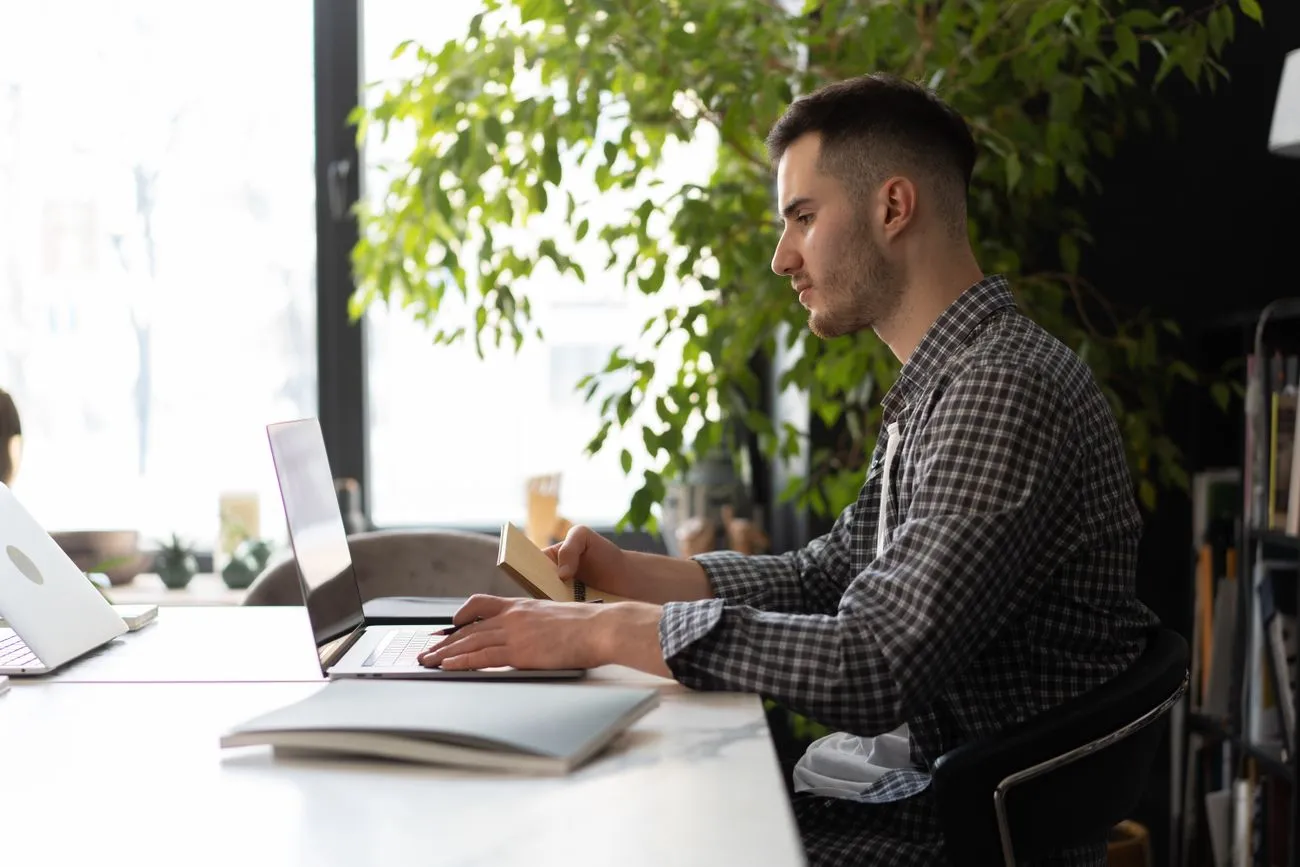 Man focused and clear-headed while working at a laptop