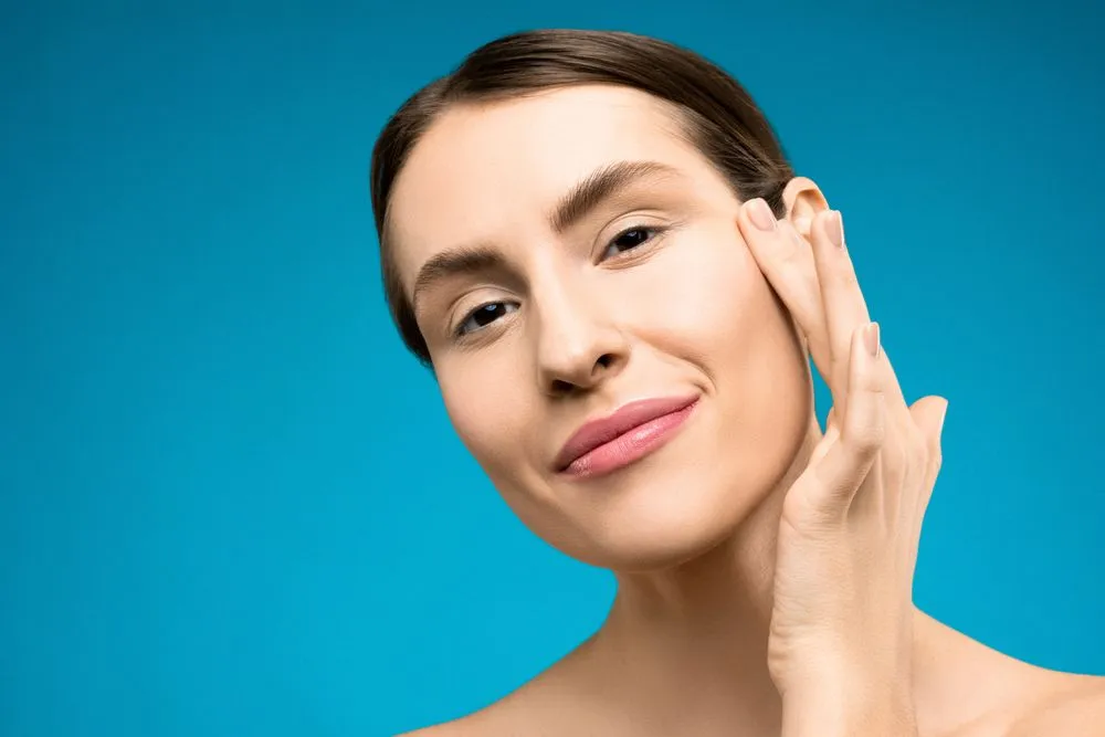 Neotonics Reviews 4 Woman with clear, radiant skin touching her face