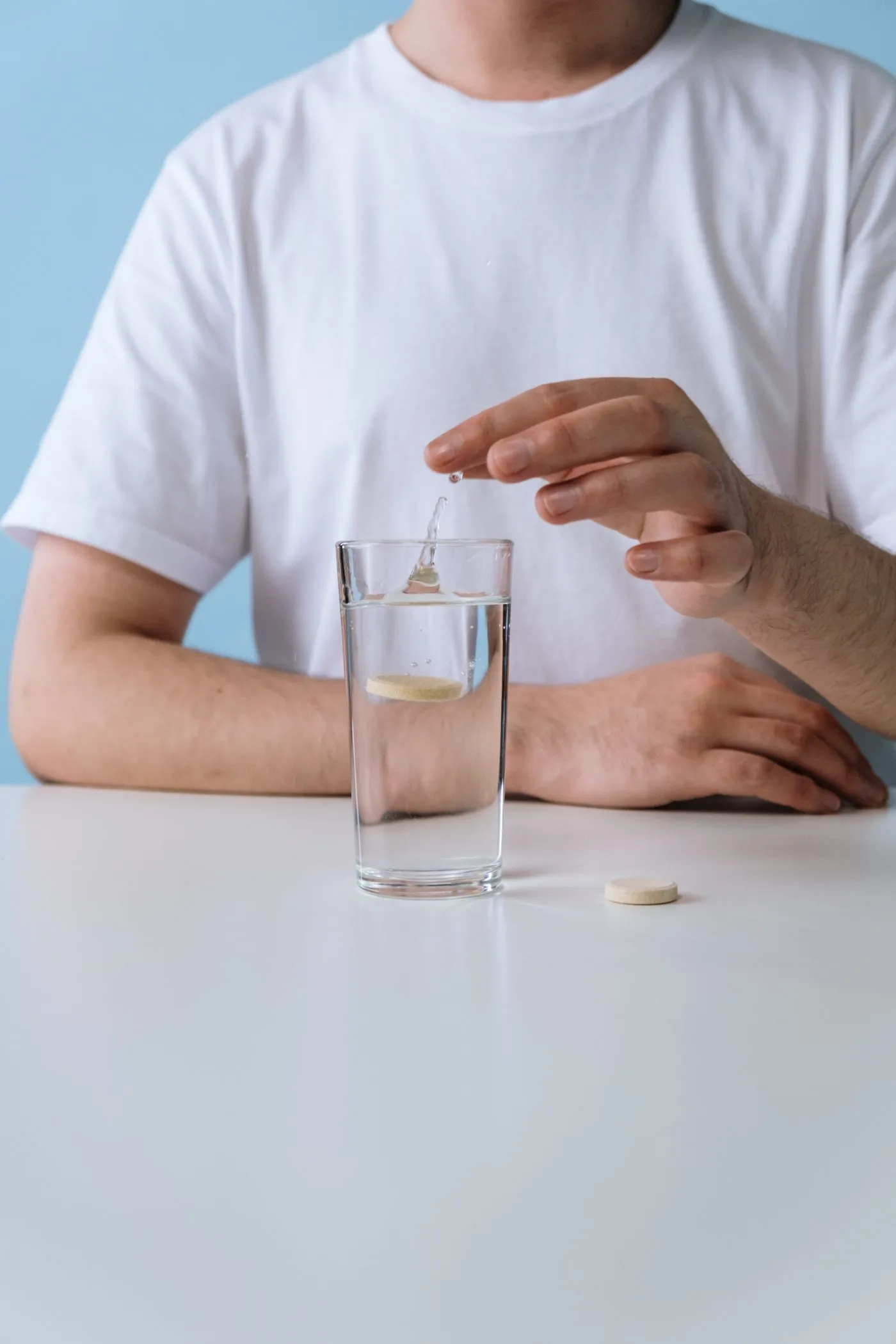PrimalTRT Reviews: Do These Primal TRT Male Vitality Gummies Work? 5 A man keeping a simple daily supplement routine with a glass of water