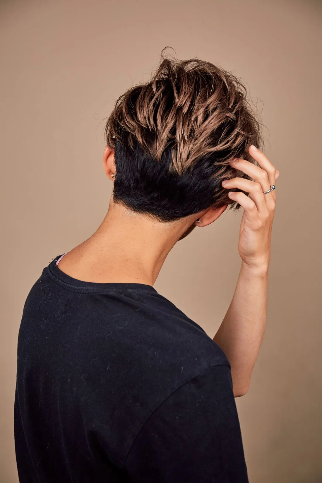 Person running a hand through thick, healthy hair