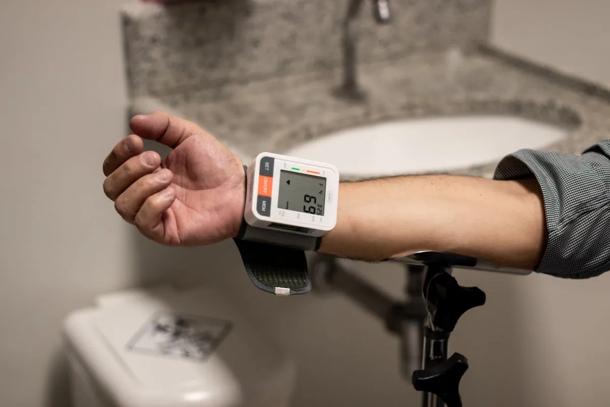 Striction BP Reviews: Does This Blood Pressure Supplement Work? 2 Person checking blood pressure with a home monitor
